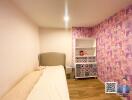 Bedroom with pink wallpaper and stuffed toys