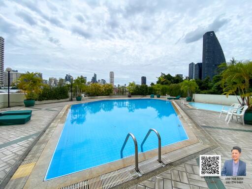 Outdoor swimming pool with city skyline view