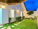 Well-lit backyard with pathway and greenery