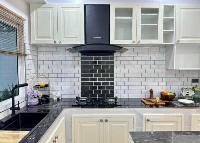 Modern kitchen with black countertops and white cabinets