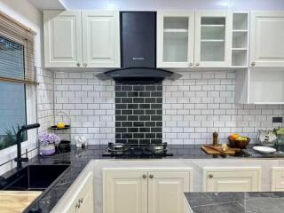 Modern kitchen with black countertops and white cabinets