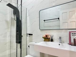 Modern bathroom with glass shower enclosure and white fixtures