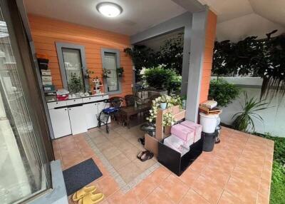 Covered outdoor balcony with storage and seating area