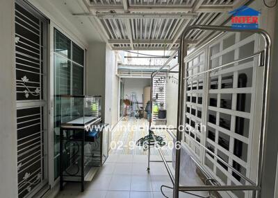 Outdoor pathway with metal shelter and decorative railing