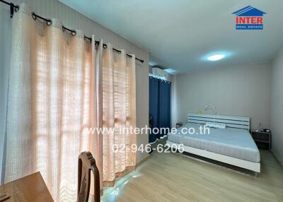 Bright and spacious bedroom with large windows and double bed