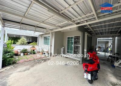 Covered outdoor area with driveway and garden