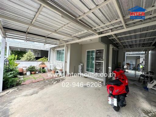 Covered outdoor area with driveway and garden