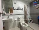 Modern bathroom with wall decorations, including a sink, toilet, and shower area