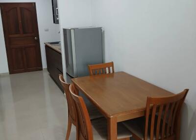 Dining area with wooden furniture and refrigerator