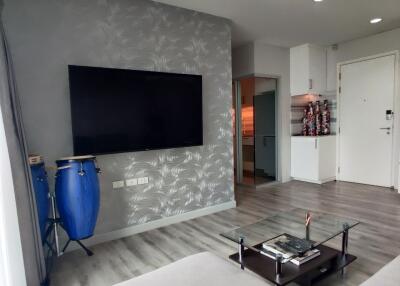 Modern living room with wall-mounted TV and minimalist decor