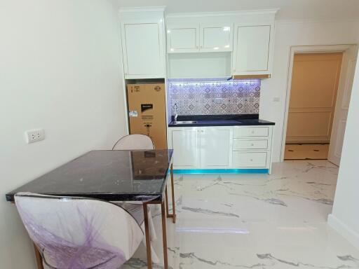 Modern kitchen area with dining table and chairs