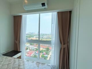 Bedroom with large window and city view