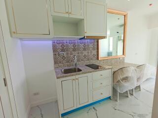 Modern kitchen with white cabinets and a tiled backsplash