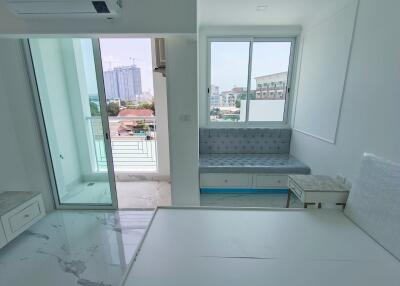 Modern living area with balcony and large window