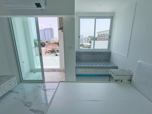 Modern living area with balcony and large window