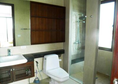 Modern bathroom with shower, toilet, and sink