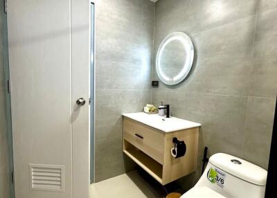 modern bathroom with vanity and circular mirror