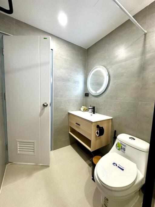 modern bathroom with vanity and circular mirror