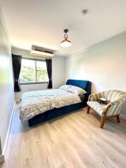 Bright and cozy bedroom with a large window