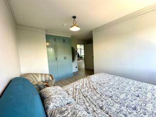 Bright, modern bedroom with blue accents and large wardrobe