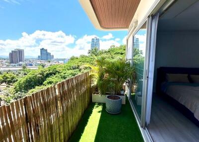 City view from narrow balcony with greenery