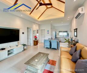 Spacious living room with high ceiling and modern amenities