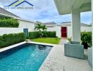 Outdoor pool area with seating and garden