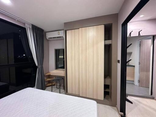 Modern bedroom with wooden wardrobe and attached bathroom