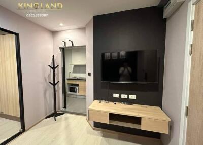 Modern living room with wall-mounted TV and wooden console