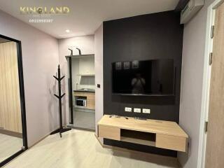 Modern living room with wall-mounted TV and wooden console