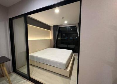 Modern bedroom with large window and sliding glass door