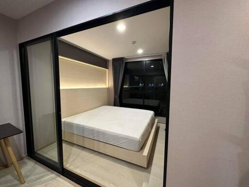 Modern bedroom with large window and sliding glass door