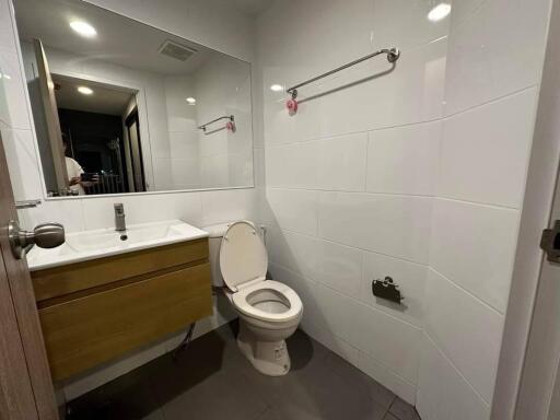 Modern bathroom with large mirror and wooden vanity