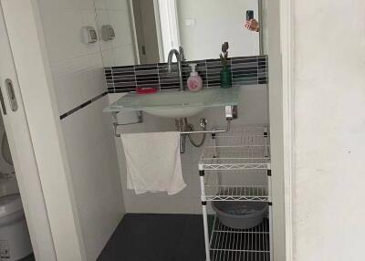 Modern bathroom with sink and storage rack