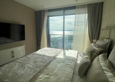 Bedroom with a large window offering a scenic view