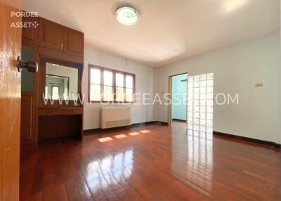 Spacious and bright bedroom with wooden floor