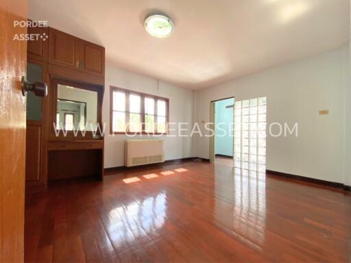 Spacious and bright bedroom with wooden floor