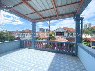 Spacious balcony with tiled flooring and a covered roof.