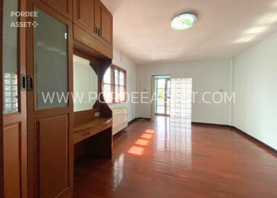 Spacious living room with large windows and wooden floor