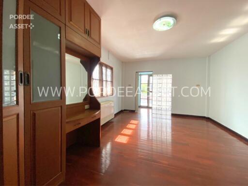 Spacious living room with large windows and wooden floor