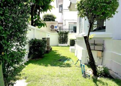 Lush green garden area next to a modern house