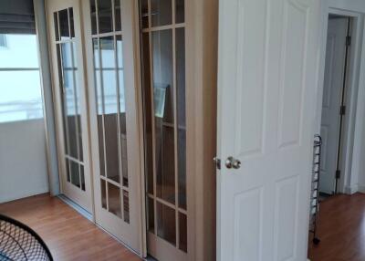 Well-lit room with large sliding doors and wooden flooring