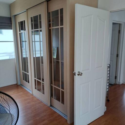 Well-lit room with large sliding doors and wooden flooring