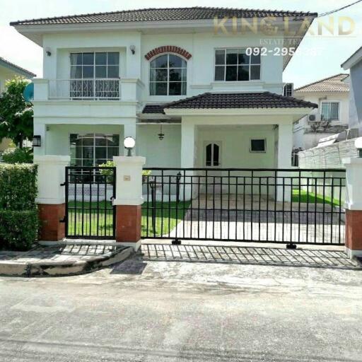 Front view of a two-story house with a gated entrance