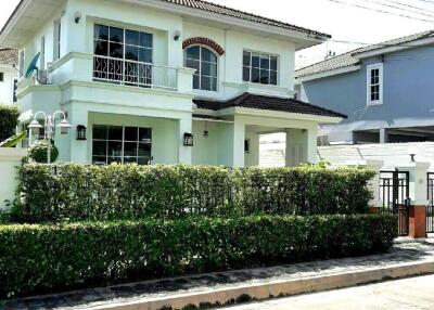 Two-story white house with garden fence