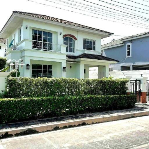 Two-story white house with garden fence