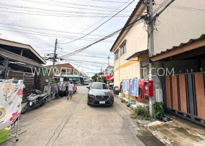 Street view with buildings, car, and laundry