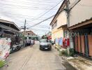 Street view with buildings, car, and laundry