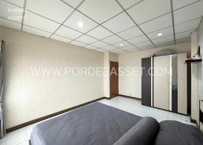 Spacious bedroom with bed and wardrobe