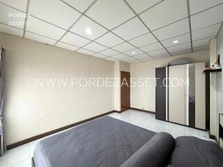 Spacious bedroom with bed and wardrobe